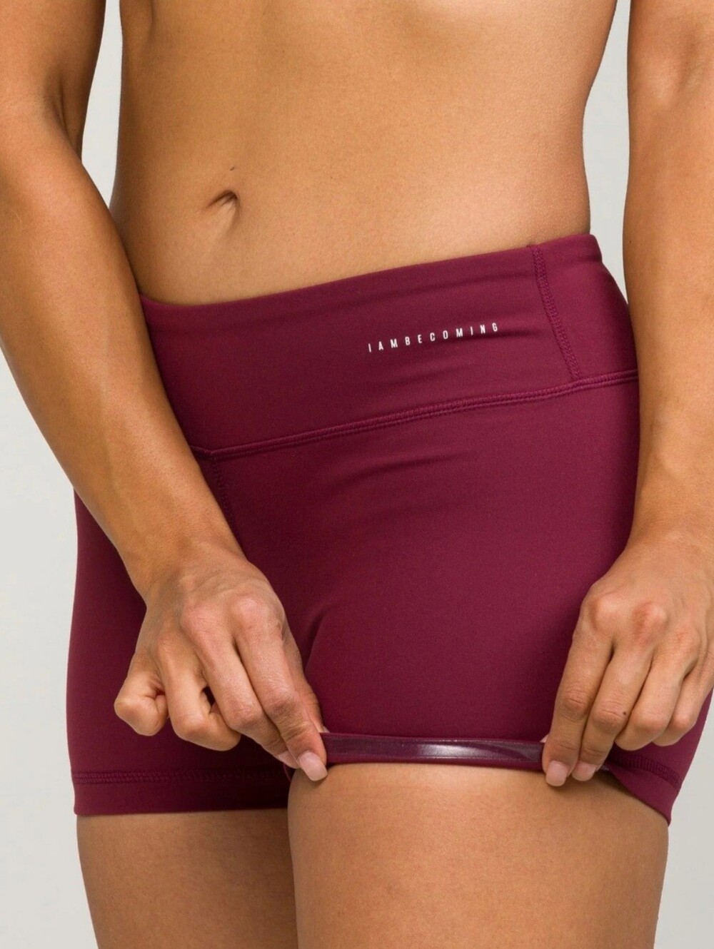 IAMBECOMING athletic shorts in wine and olive green featuring a high-waist